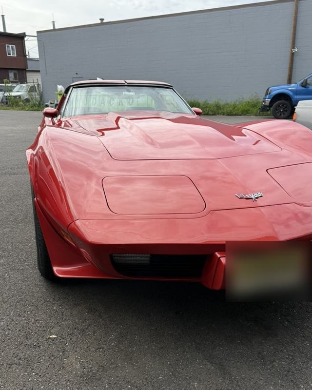 Red Corvette parked in a lot